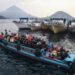 People travel on a wooden boat with motor scooters to Tidore Island ahead of Eid al-Fitr, which marks the end of the Muslim fasting month of Ramadan, at Bastiong port in Ternate, North Maluku